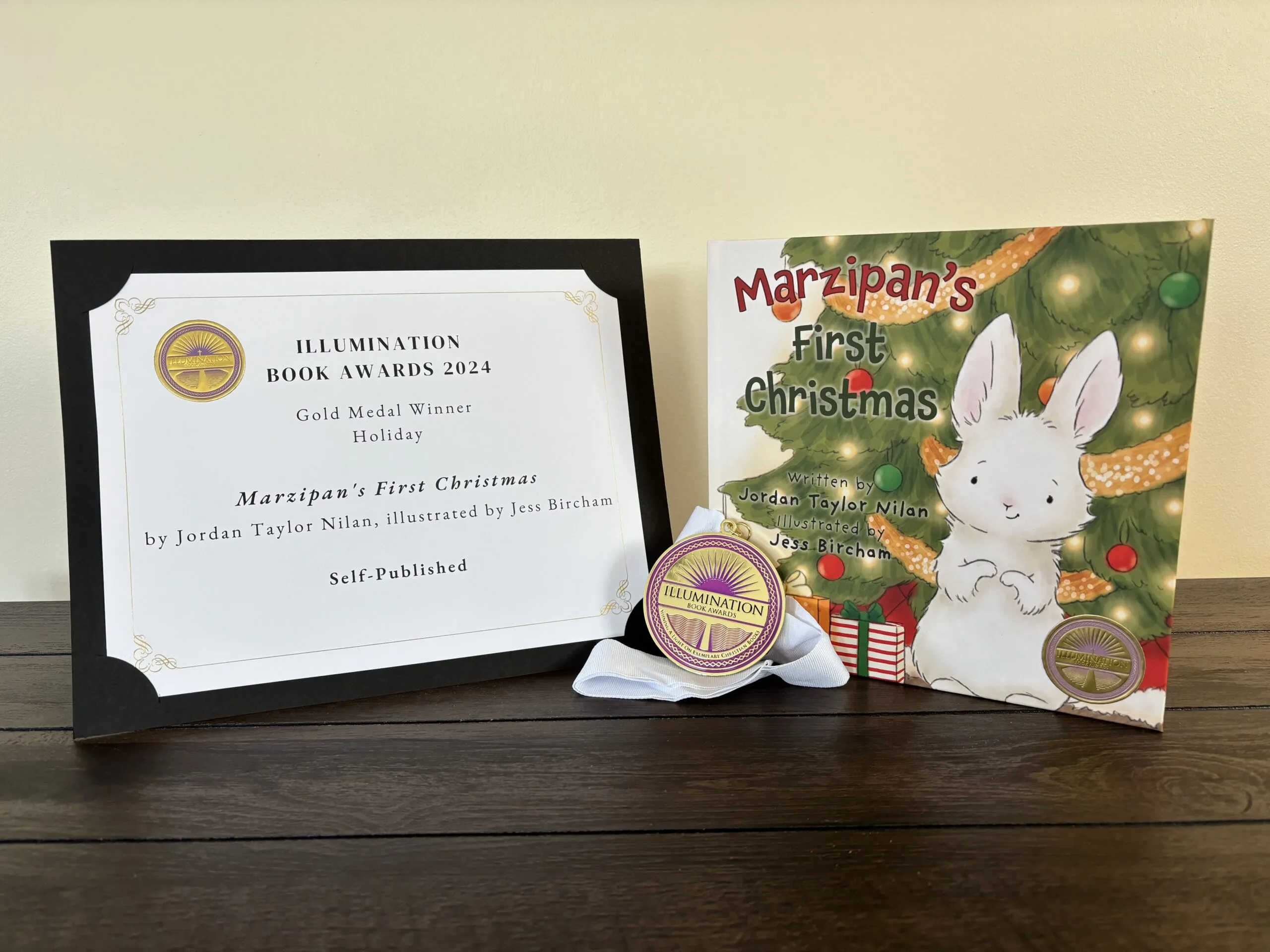 The book Marzipan’s First Christmas by Jordan Taylor Nolan alongside her Illumination Christian Book Awards medal